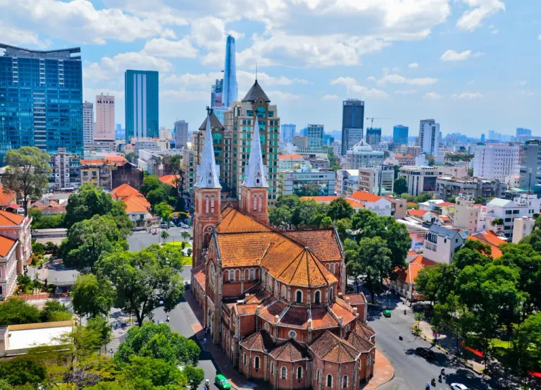 Offshore development Australia concept illustrated through Ho Chi Minh City skyline with Notre Dame Cathedral and modern business district